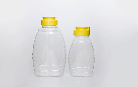 Plastic queenline jar for honey storage with yellow sealed lids