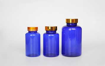 Gold lid blue prescription medicine plastic storage bottles